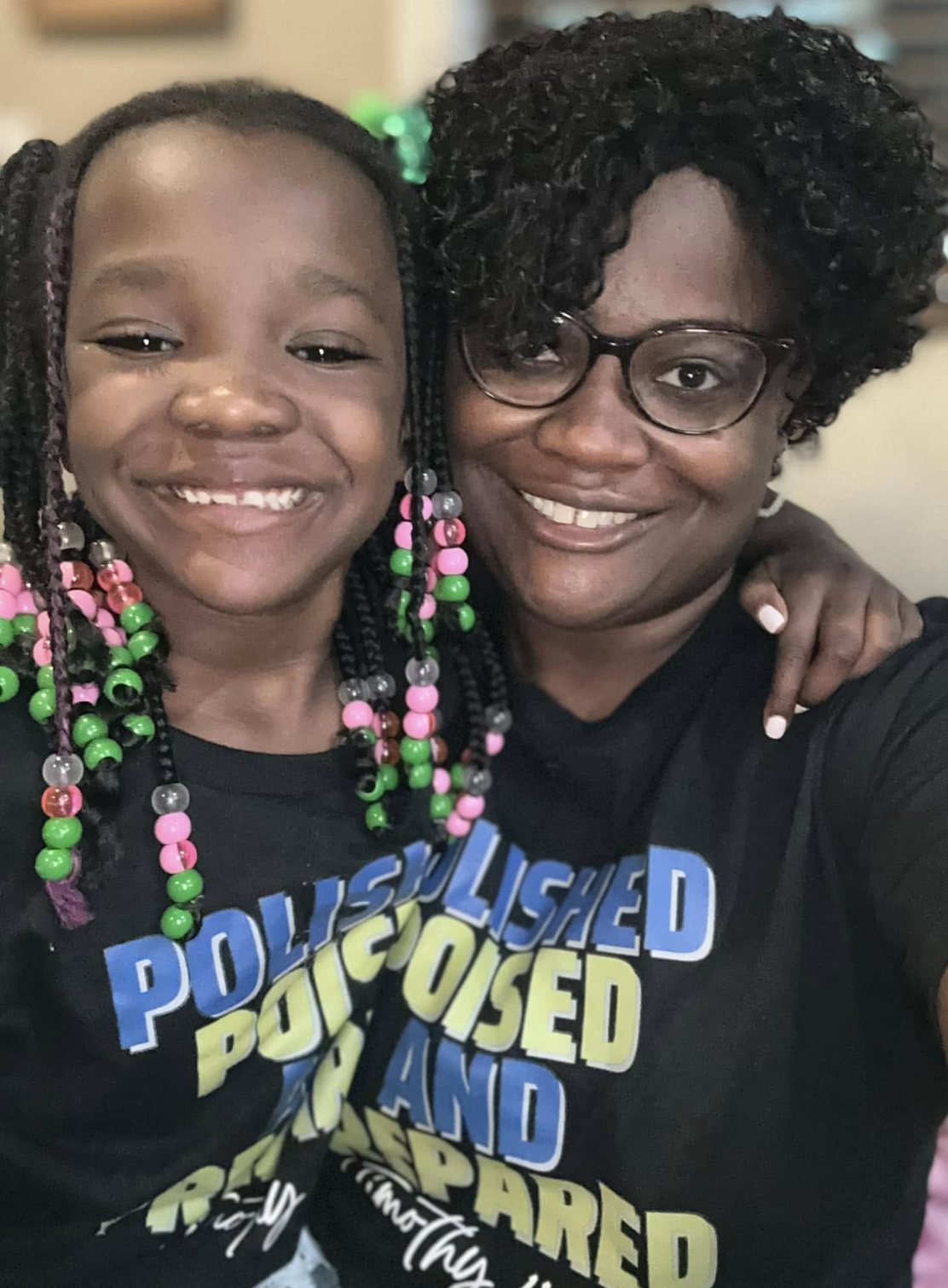 Founder Amy Ogunyemi and her daughter smiling in matching Polished, Poised, and Prepared shirts